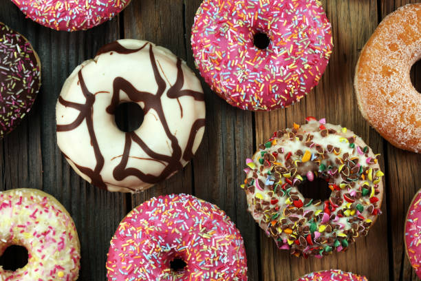 istock assorted donuts with chocolate frosted, pink glazed and sprinkles donuts 1017302870
