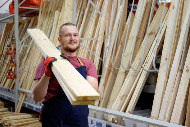 worker or seller in construction store or warehouse wood section at work