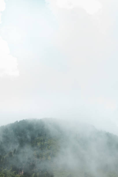 istock white fog over green mountain peak 1017311730