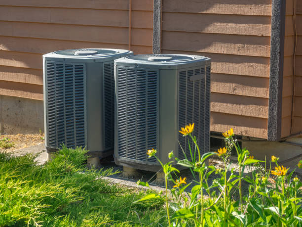 Air conditioning units outside an apartment complex stock photo