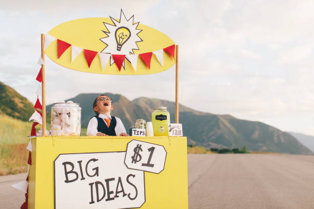istock Young Business Boy Runs Big Idea Stand 1017317326