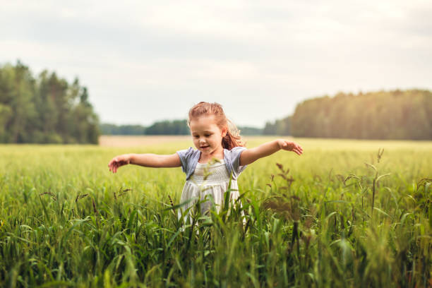 istock little girl runs through a green meadow 1017325466