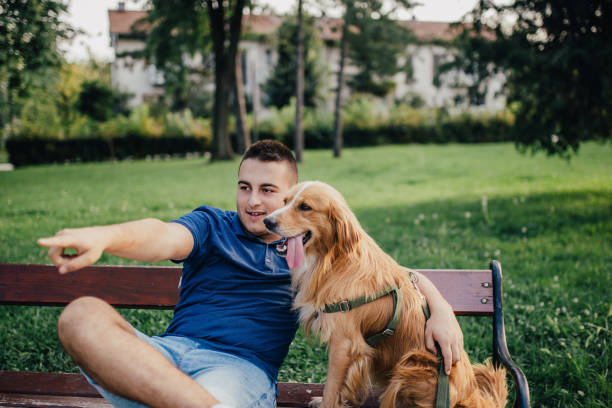 istock Guy and his dog, golden retriever, nature 1017326440