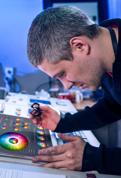 istock Man in the process of offset printing and color correction 1017328518