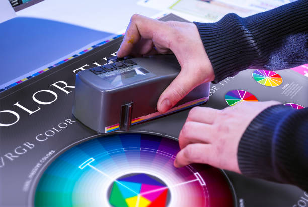 Man in the process of offset printing and color correction