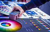 Man in the process of offset printing and color correction
