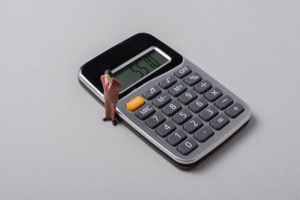 istock Man stands beside a calculator 1017343156