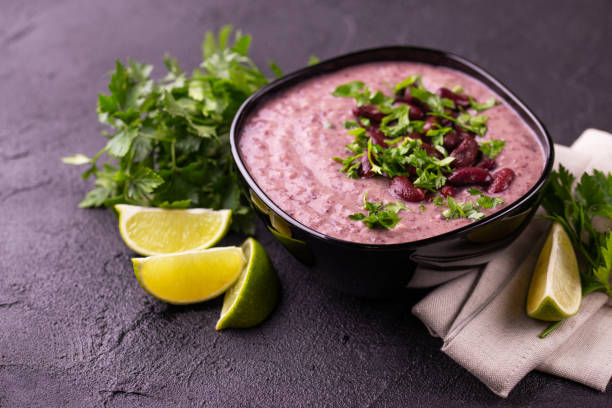 istock Mexican bean puree soup with lime, parsley and chilli pepper. 1017352472