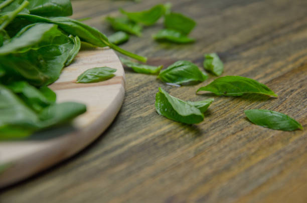 istock Basil leaves on a wooden table selective  focus 1017355370