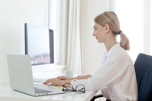 istock Smiling young businesswoman on desk 1017355456