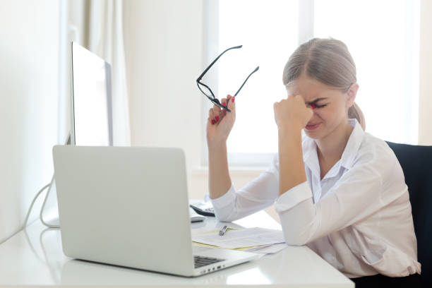 istock Businesswoman rubbing eyes in office 1017355522