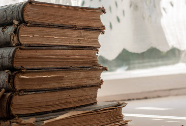 istock a stack of old vintage books lies on the windowsill 1017362412