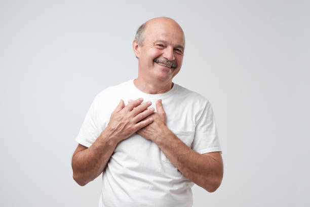 istock Cheerful man smiles happily, keeps hands on chest. 1017364590