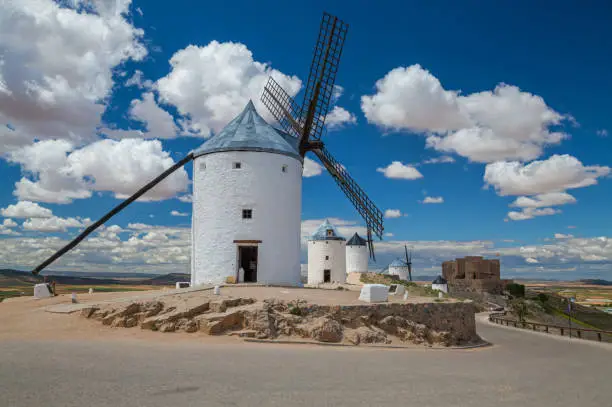 Beautiful snow-white windmills on blue sky background in Consuegra, province of Toledo, Spain.