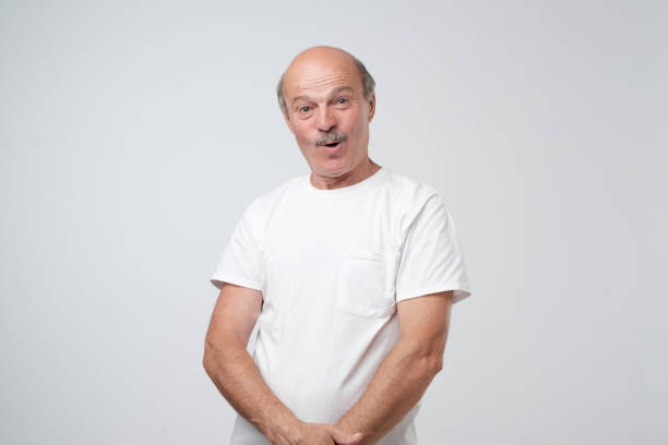 istock Senior emotional surprised man standing with opened a little mouth. 1017384824
