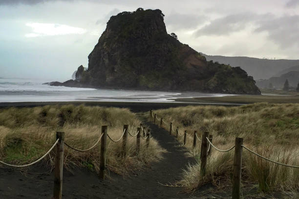 istock Huge rock formation off the beach in bad weather 1017387622