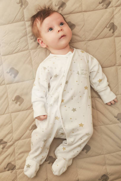 istock Adorable two months old baby in the bed 1017395050