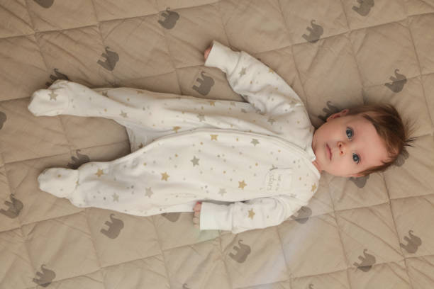 istock Adorable two months old baby in the bed 1017395440