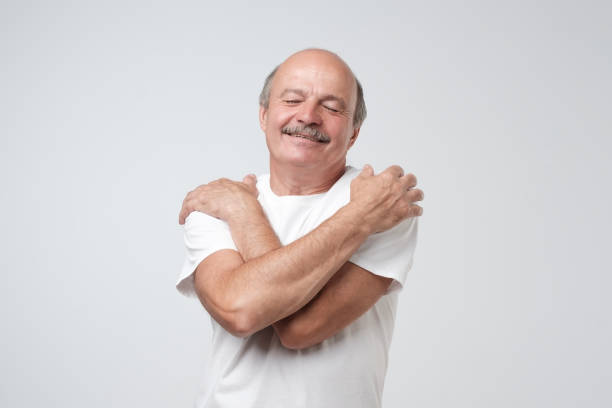 istock Closeup portrait confident smiling man hugging himself. I am the best concept. 1017405212
