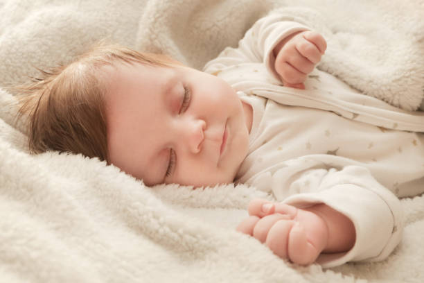 istock Adorable two months old baby in the bed 1017405480