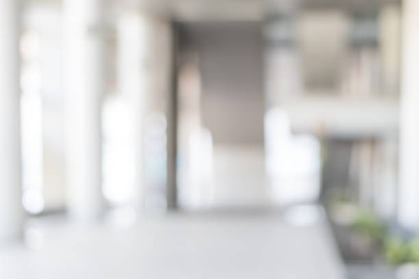istock Blur office background building exterior view to lobby glass window wall with blurry light bokeh 1017408404