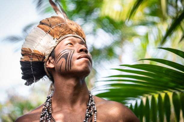 Indigenous Brazilian Young Man Portrait from Guarani Ethnicity Beautiful shooting of how Brazilian Native lives in Brazil Sustainable Lifestyle brazilian culture stock pictures, royalty-free photos & images
