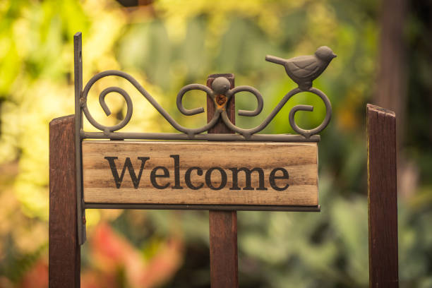 istock Welcome vintage wooden sign on a soft background blur . 1017418452