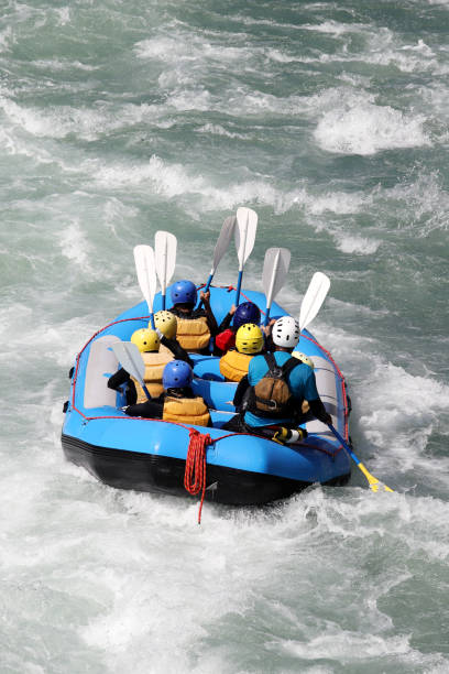 white water rafting on the rapids of river - team sport rafting white water rafting rapid imagens e fotografias de stock