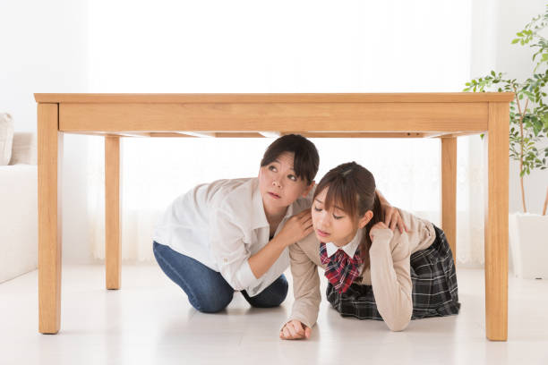 istock asian mother and daughter escaping under a table 1017437794
