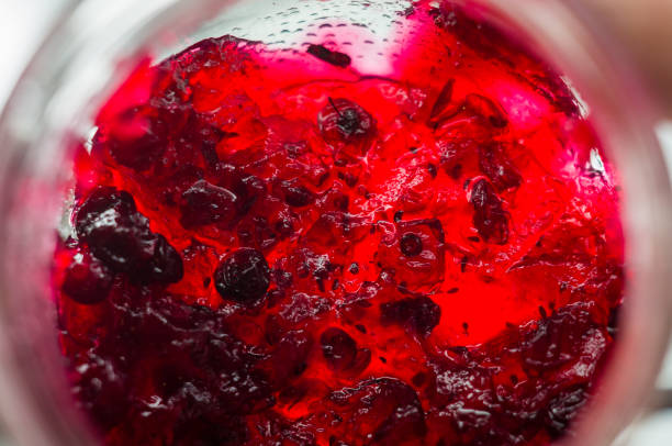 istock Bright translucent red currant jam in a glass jar 1017437830