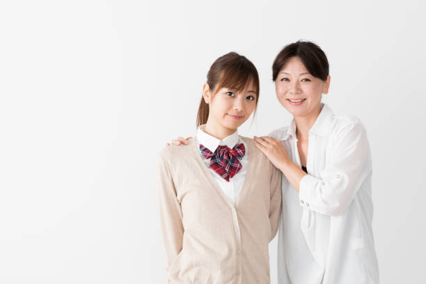 istock young asian mother and daughter on white background 1017437848