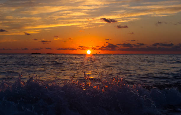 istock Amazing sea sunset on the pebble beach, the sun, waves, clouds 1017437976
