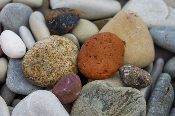 istock boulders and colorful pebbles on the beach 1017448102
