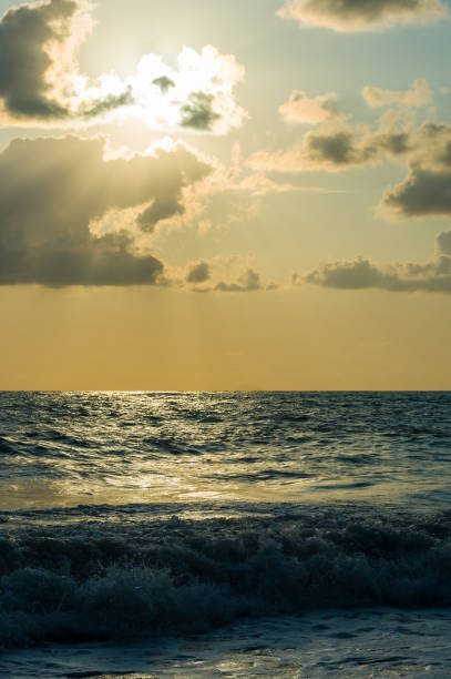 istock Amazing sea sunset on the pebble beach, the sun, waves, clouds 1017448296