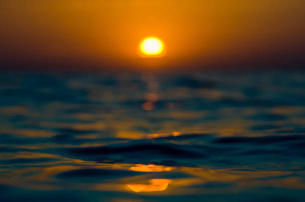 istock Amazing sea sunset on the pebble beach, the sun, waves, clouds 1017453280