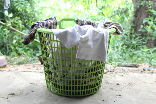 istock Pile of clothes overflow plastic laundry basket for washing 1017466846