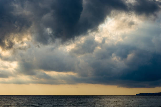 istock Amazing sea sunset on the pebble beach, the sun, waves, clouds 1017471680