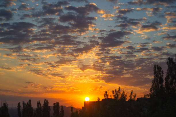 Landscape with dramatic light - beautiful golden sunset with saturated sky and clouds, peaceful nature serene background.