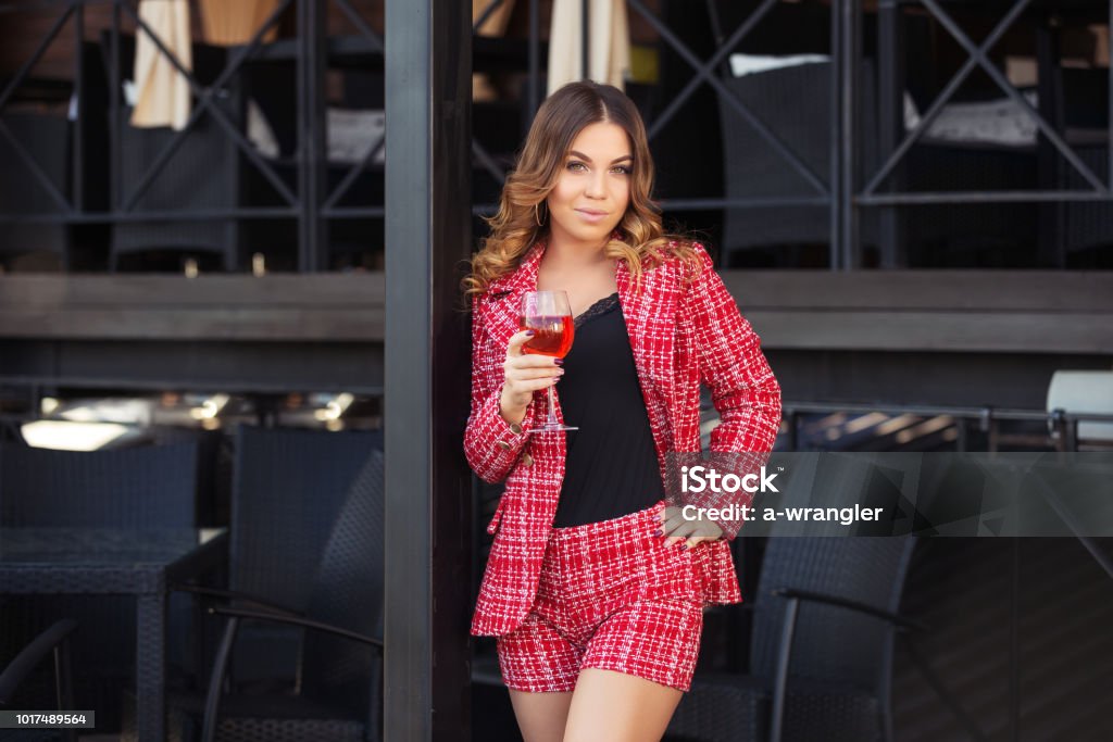 Young Fashion Woman In Red Tweed Jacket And Shorts Suit At