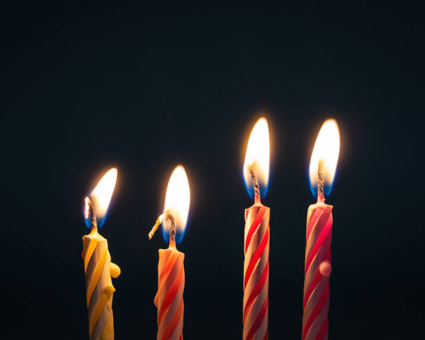 istock Burning birthday candles on dark background with fire. 1017497110