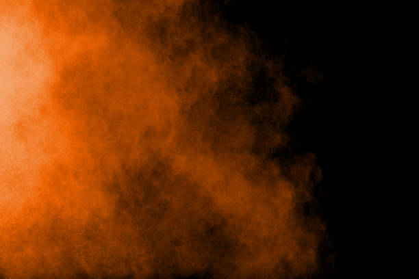 istock abstract orange dust explosion on  black background. abstract orange powder splattered on black background, Freeze motion of orange powder splash. 1017505474