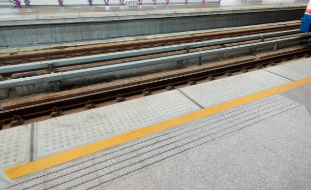 Do not cross the line sky train, yellow sign caution at Bangkok, Thailand.