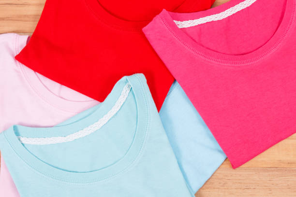 istock Colorful shirts or sweater for woman on rustic board 1017514862