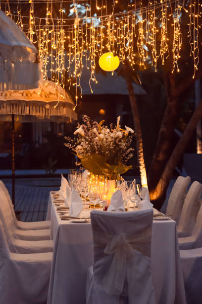 istock Wedding Banquet or gala dinner decorated with garlands. Festive table set up decor for wedding, party or event 1017517502