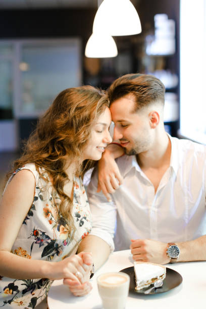istock Young nice girl and boy sitting at cafe, drinking coffee and resting 1017519642