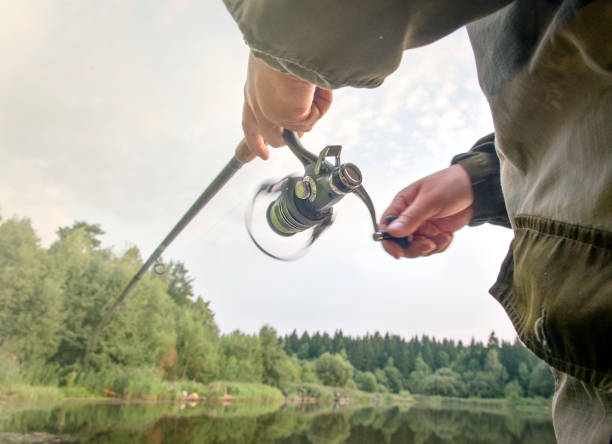 istock A man catches a fish with a rod in his hands. 1017519728