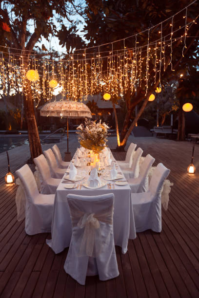 istock Wedding Banquet or gala dinner decorated with garlands. Festive table set up decor for wedding, party or event 1017526584