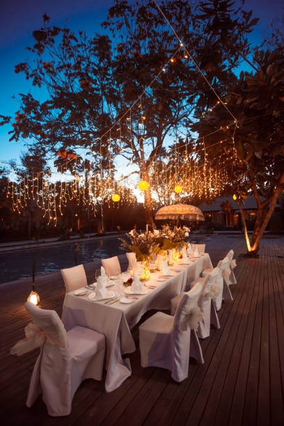 istock Wedding Banquet or gala dinner decorated with garlands. Festive table set up decor for wedding, party or event 1017526612