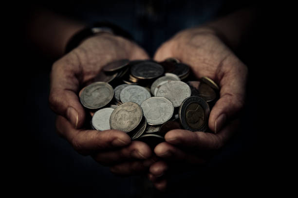 istock A coins in people hands in saving money concept 1017528840
