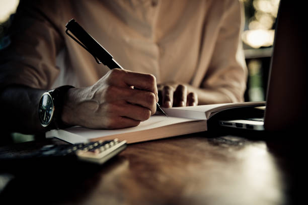 istock Close up women hand on writng on notebook and work with calculator 1017528842